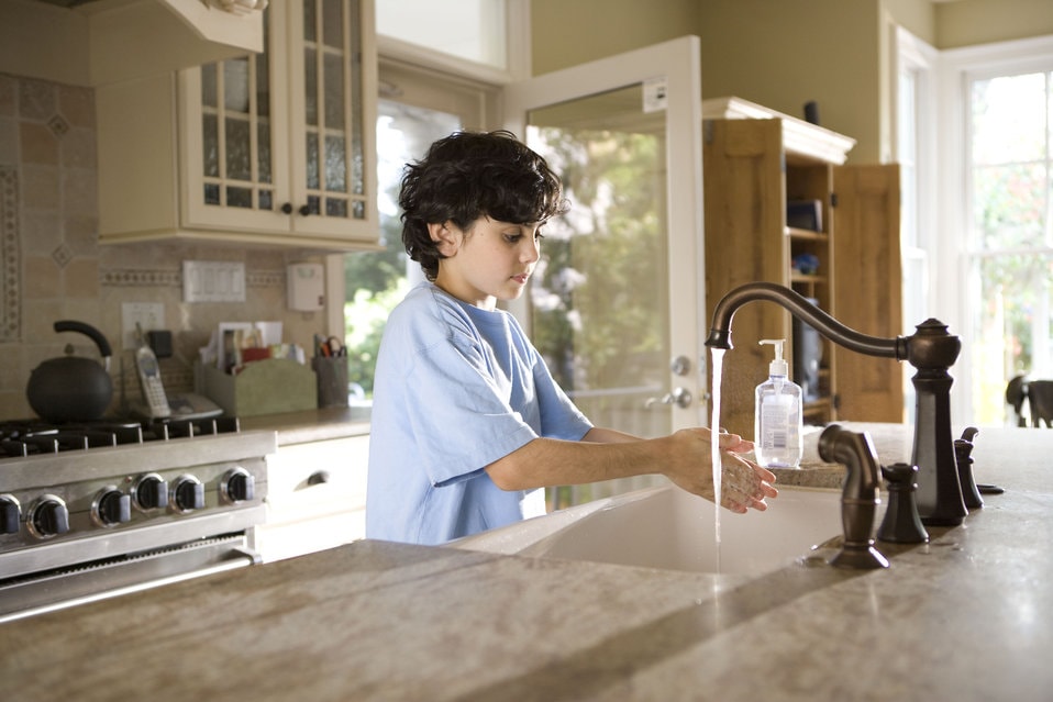 a boy washing his hands