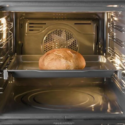 Clean oven interior with a roasting tray on the shelf